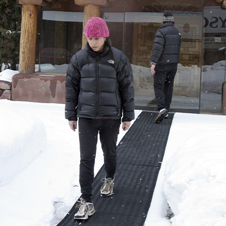 Portable heated traction mat.