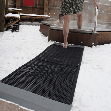 Portable heated traction mat leading to hot tub.